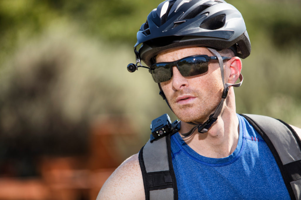 Man using Venture bodycam on backpack and clipped on helmet